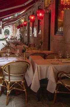 Empty cozy outdoor restaurant terrace in Venice Stock Photos