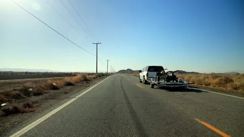An empty cracked desert road with bright yellow lines that quickly Stock Footage 150765266