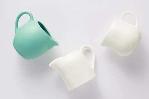 Empty cream jug on white background Stock Photos