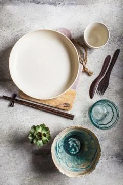 Empty crockery background. Pottery empty bowl and plate on gray background. Stock Photos