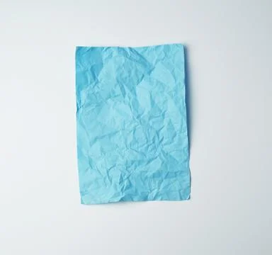 Empty crumpled blue rectangular sheet of paper on a white background Stock Photos