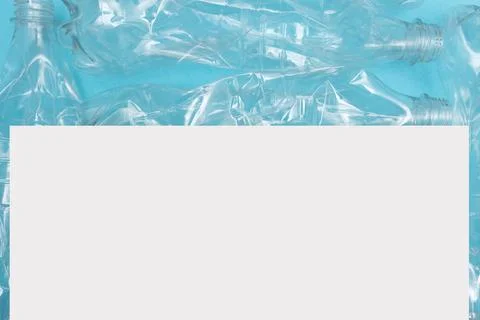 Empty crumpled plastic bottles on blue background with place for text. Copy Foto stock