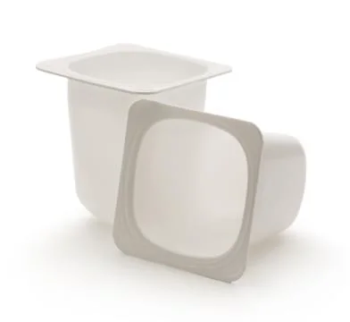 Empty crushed plastic yogurt pots Foto stock