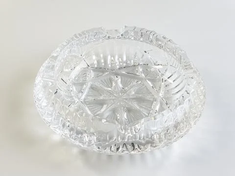 Empty crystal ashtray on a white background. The ashtray was made in the mid- Stock Photos