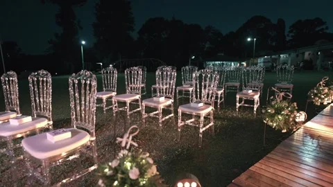 Empty Crystal Chairs for Outdoor Wedding Ceremony at Night in Elegant Garden 스톡 동영상 334385866