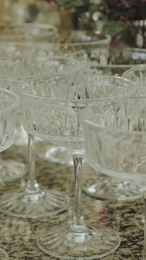 Empty crystal glasses stand on a wine rack in a coupe, perfectly prepared for Stock Footage 306591148