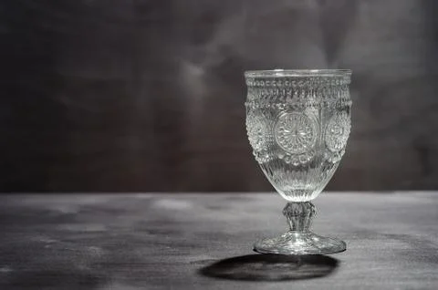 Empty crystal pancake with a pattern, on a dark wooden background Stock Photos