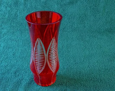 Empty crystal vase on green background. The vase was made in the mid-20th cen Stock Photos
