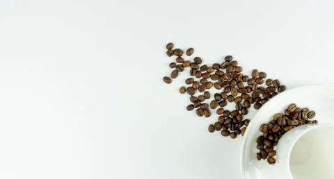 Empty cup and coffee beans on a white background. place for text. Top view. F Stock Photos