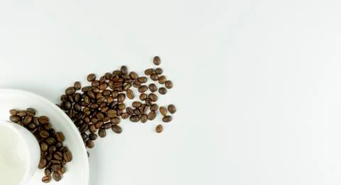Empty cup and coffee beans on a white background. place for text. Top view. F Stock Photos