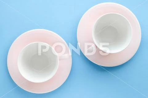 Empty cup and saucer on blue background, flatlay Stock Photos