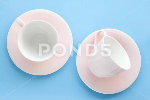 Empty cup and saucer on blue background, flatlay Stock Photos