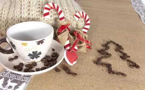 An empty cup of coffee surrounded by some christmas decoration Stock Photos