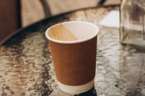 Empty cup of coffee under the table Photos