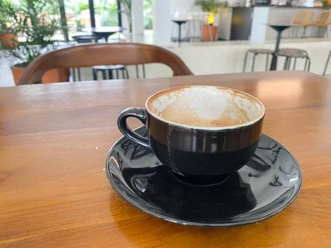 Empty cup of coffee on wooden table in the cafe Stock Photos