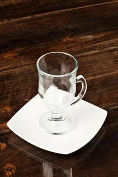 Empty cup placed against a sleek and polished table top,creating a visually Foto stock