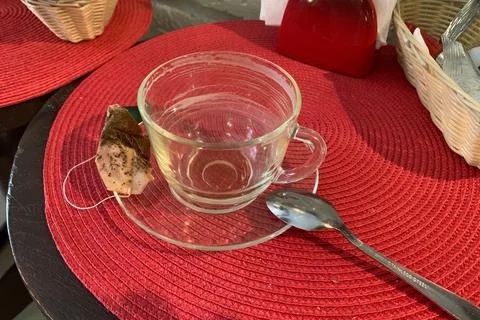 Empty cup of tea with a saucer on  table with a tea bag. drunk empty mug Stock Photos