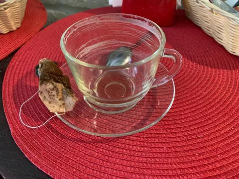 Empty cup of tea with a saucer on  table with a tea bag. drunk empty mug Stock Photos