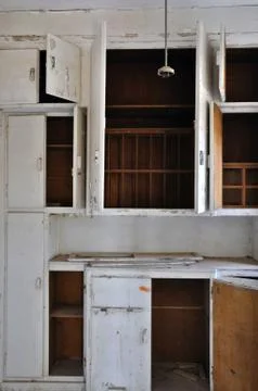 Empty cupboards in abandoned kitchen Stock Photos