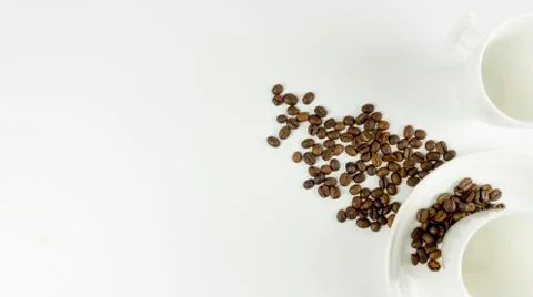 Empty cups and coffee beans on a white background. place for text. Top view. Stock Photos