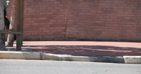 Empty curb and pink path are staying still until pedestrians enter, walking past Stock Footage 339651809