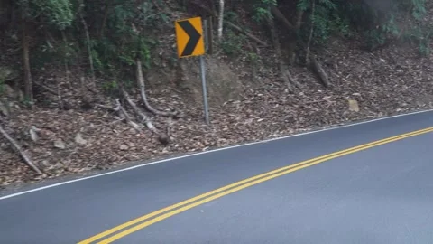 Empty Curved Road on a Hillside with Yellow Line Marking Stock Footage 264959403