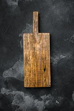 Empty cutting board, on black dark stone table background, top view flat lay  Stock Photos
