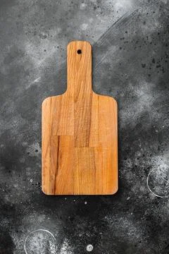 Empty cutting board, on black dark stone table background, top view flat lay Stock Photos