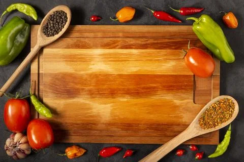 Empty cutting  board on the table with Ingredients for cooking. Tomatoes, v.. Stock Photos