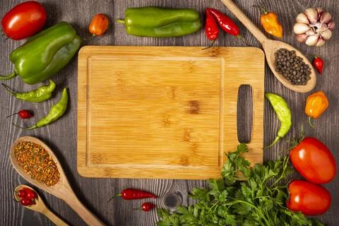 Empty cutting  board on the table with Ingredients for cooking. Tomatoes, v.. Stock Photos