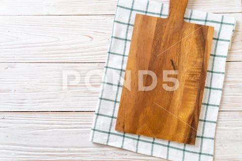 Empty cutting wooden board with kitchen cloth Stock Photos