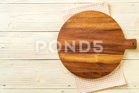 Empty cutting wooden board with kitchen cloth Stock Photos