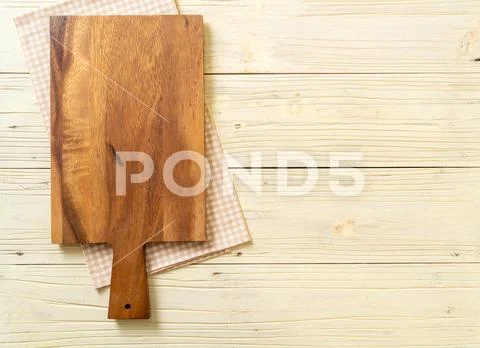 Empty cutting wooden board with kitchen cloth Stock Photos