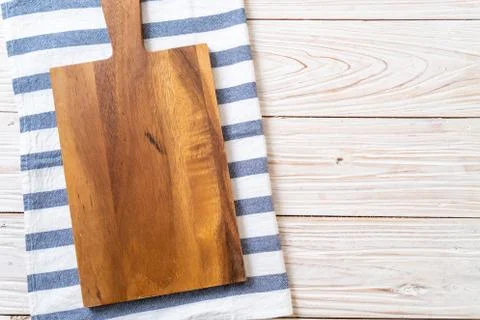 Empty cutting wooden board with kitchen cloth Stock Photos