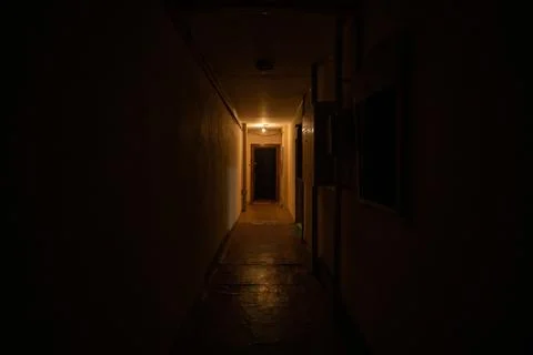 Empty dark corridor with light at the end. Stock Photos