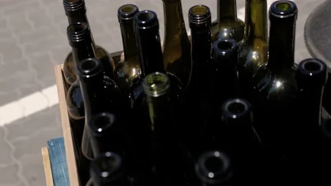 Empty dark glass bottles from wine. Sunny summer day. Close-up Stock Footage 132099365