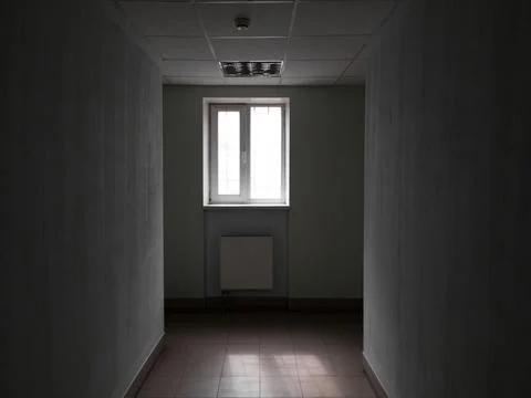 Empty dark office corridor with window in the end Foto stock