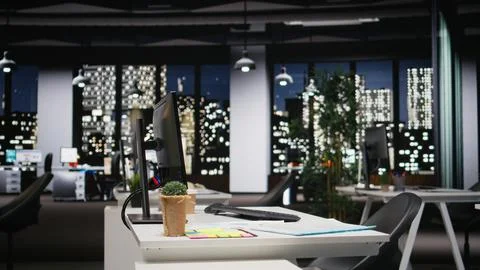 Empty dark office features high tech gadgets and dual monitors Stock Photos