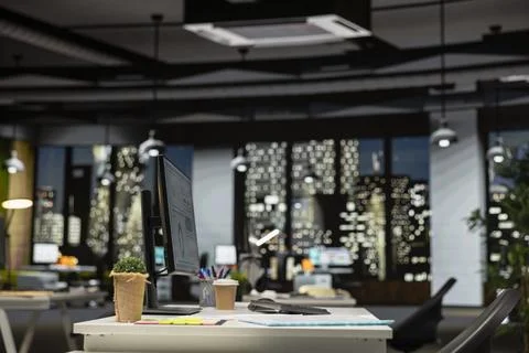 Empty dark office features high tech gadgets and dual monitors Stock Photos