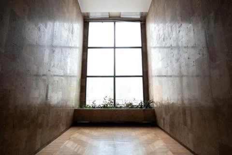 Empty, dark room with big window and marble walls Stock Photos