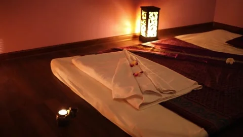 Empty dark room with mats for thai massage and lamps on floor Stock Footage 276364950