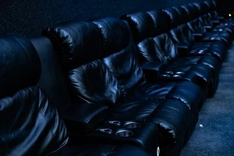 Empty dark rows of blue cinema seats in auditorium 스톡 사진