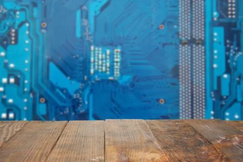 Empty dark rustic wood table with blurred abstract blue background electronic Stock Photos