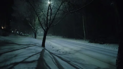 Empty dark snowy road in winter Stock Footage 297599011