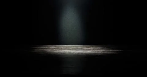 An empty dark stage with a light in the centre. An advertising concept for your 库存照片