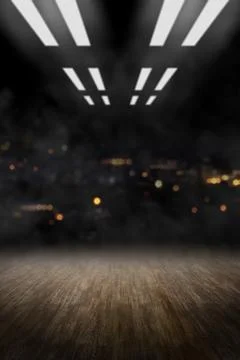 An empty dark stage with a textured ground, bright overhead studio lights, .. Stock Photos