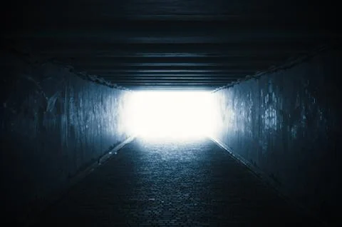Empty dark tunnel with light in the end Stock Photos