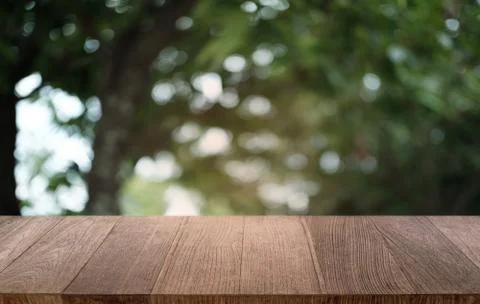 Empty dark wooden table in front of abstract blurred bokeh background of rest Stock Photos