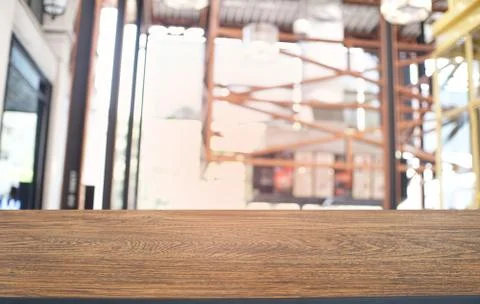 Empty dark wooden table in front of abstract blurred bokeh background of rest Stock Photos