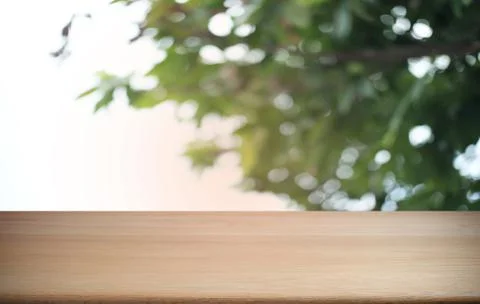 Empty dark wooden table in front of abstract blurred bokeh background of rest Stock Photos